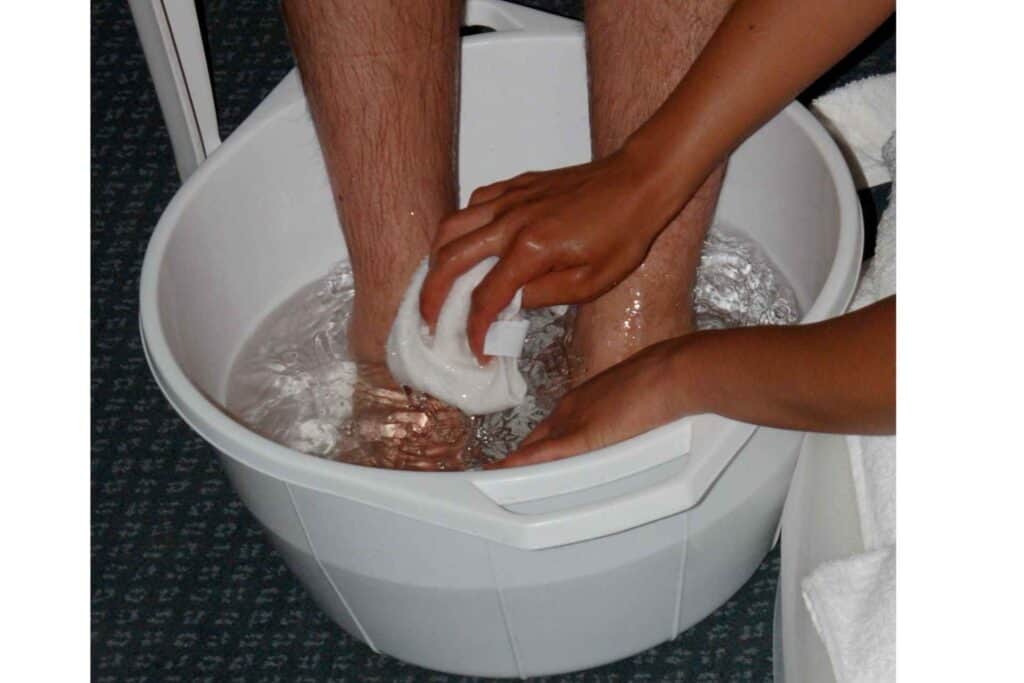 A man washing feet in feet tub