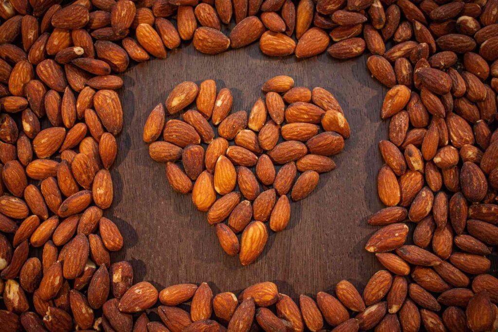 Heart art from almonds table background