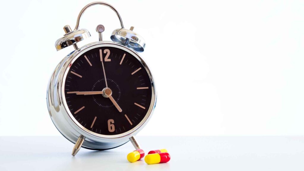A clock with medicines (taking medicine on time, concept) 