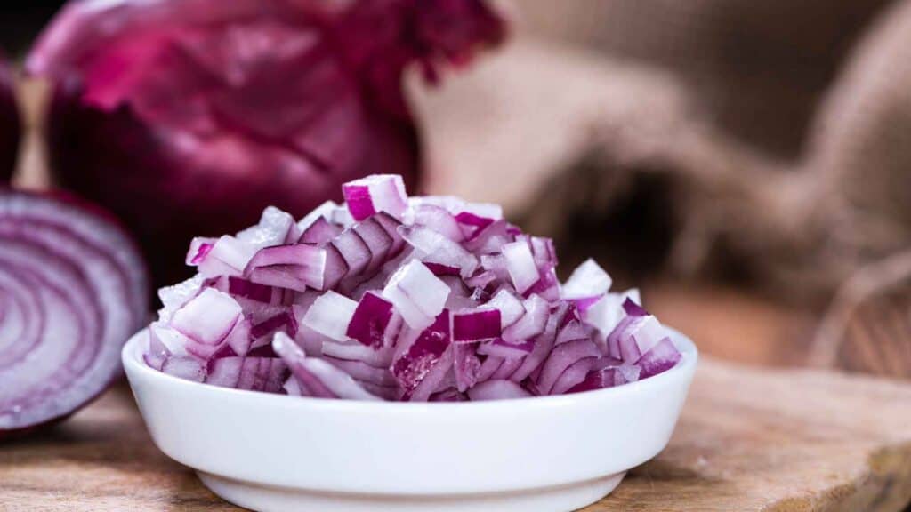 half cup sliced red onion in a bowl