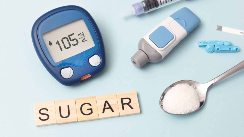 blood glucose monitor  kit with spoon of sugar