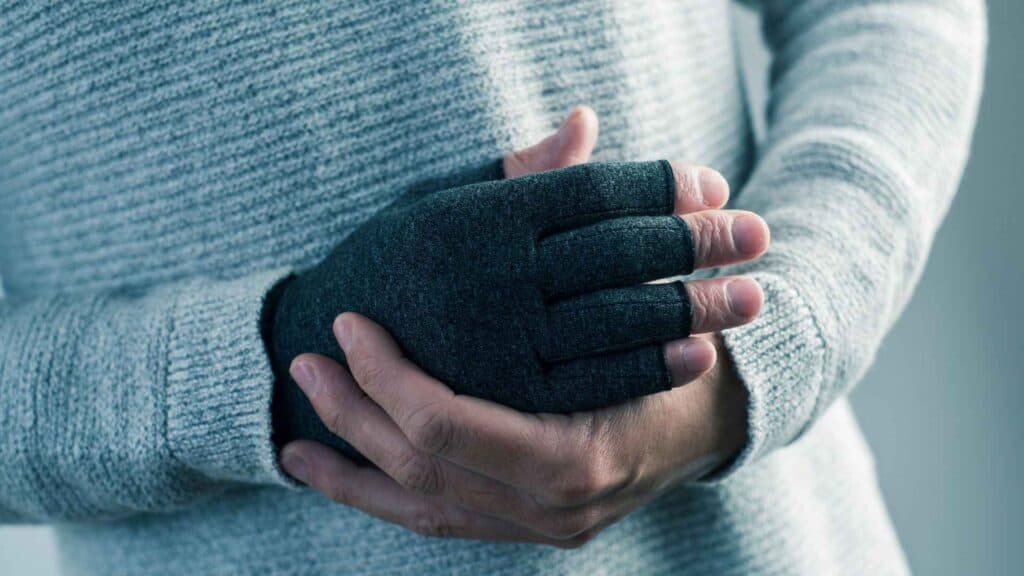 A man hands with compression gloves
