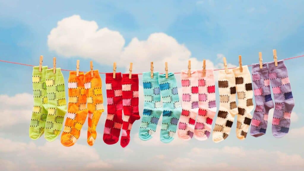 Different colors compression socks hanging from rope