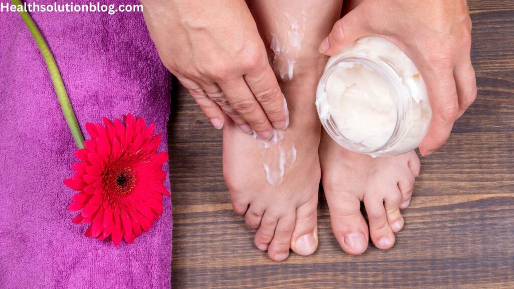 A man applying moisturizing cream on feet