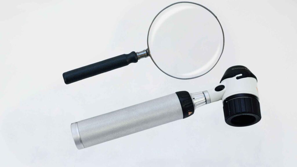 A magnifying glassm and dermatoscope
