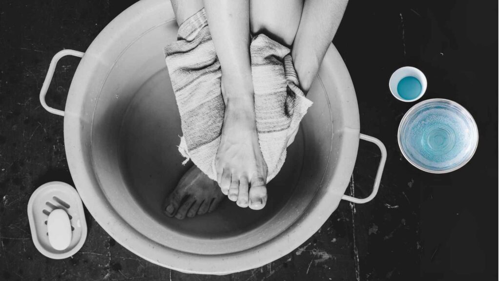A person washing and drying feet